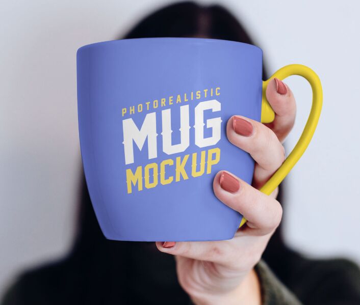 Mug in Female Hand Mockup PSD